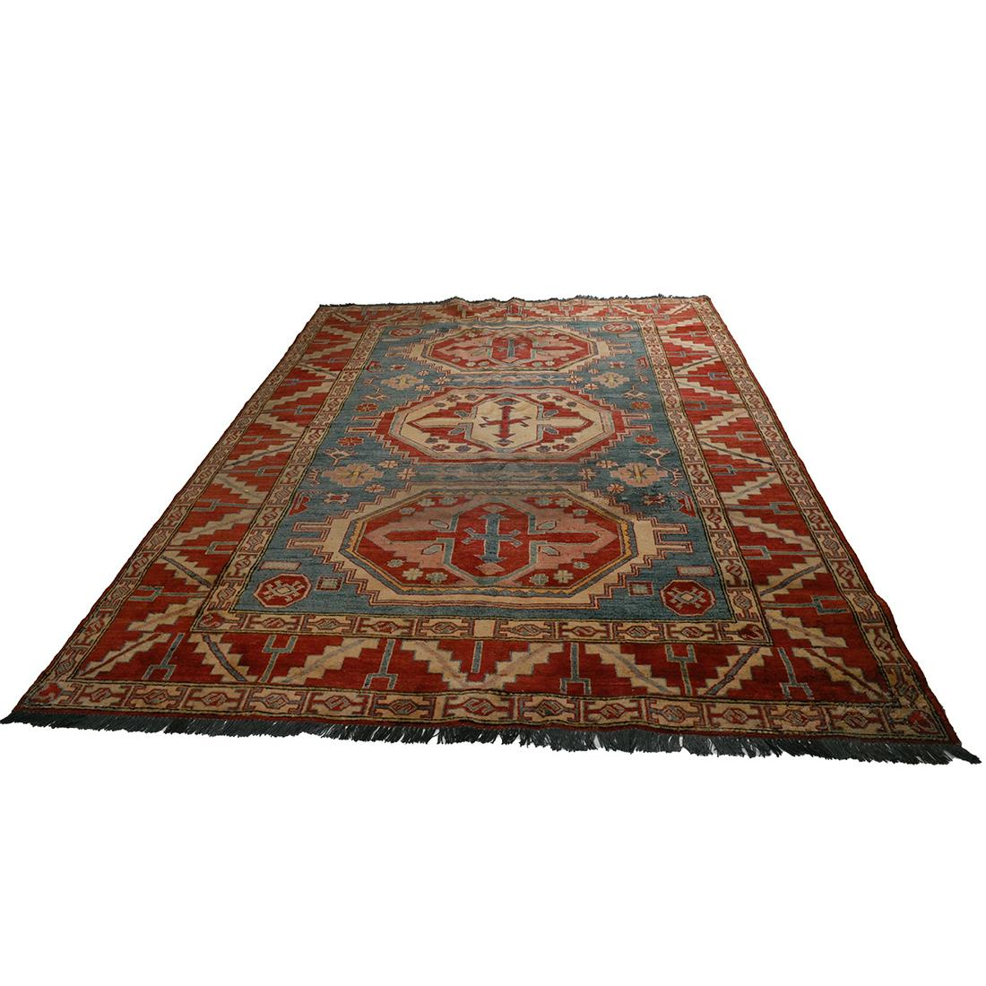 Pakistani Wool Carpet.: Pakistani Wool Carpet. Three central medallions on a blue ground, red main border, geometric motifs throughout. {Approximate dimensions: 10 feet 2 inches x 7 feet 3 inches.}. Condition: Some dark spot