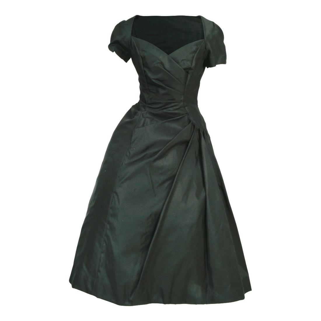 Estevez Black Silk Satin Evening Dress.: Estevez Black Silk Satin Evening Dress. Label to back ESTEVEZ.Sweetheart cut, angle pleated bodice with cap sleeves, with dramatic, pleat gathered to side panels. Mesh net skirting underneath. Zip off