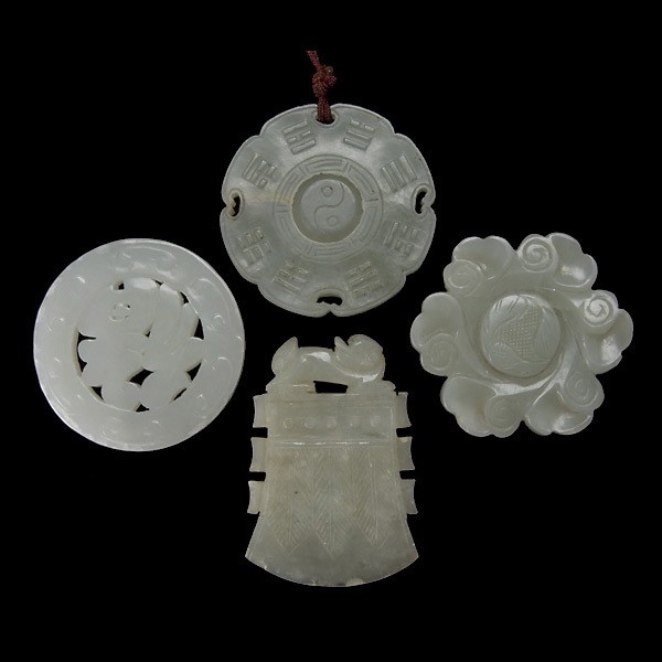 Four Jade Pendants: Four Jade Pendants, including one circular pendant, two flower form pendants, and one ax form pendant {Diameter of circular pendant 2 1/4 inches} [Chips]