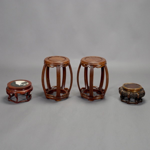 A Group of Two Garden Seats and Two Wood Stands: A Group of Two Carved Wood Garden Seats with Two Finely Carved Wood Stands, the stools of barrel form; the first wood stand with a circular stone tope; the second wood stand with reticulated decoratio