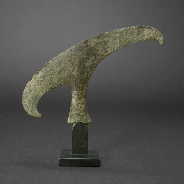 Dong Son Style Bronze Ritual Ax on Stand: SOUTHEAST ASIA. Dong Son Style Bronze Ritual Ax on Stand. Provenance: Purchsed by the former owner from Frank Wiggers in 1993 L = 12 1/2 inches Repaired near center.