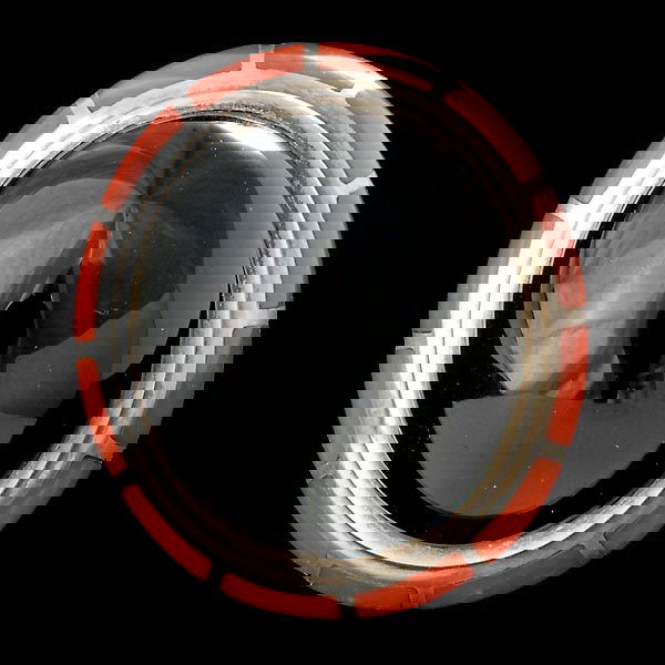 BLACK ONYX, CORAL STERLING SILVER SOLEIL NOIR RIN: BLACK ONYX, CORAL, STERLING SILVER SOLEIL NOIR RING WITH ERTE BOOK Centering one oval black onyx cabochon measuring approximately 24.15 X 20.60 X 12.90 mm, accented by twelve coral rectangular plaques