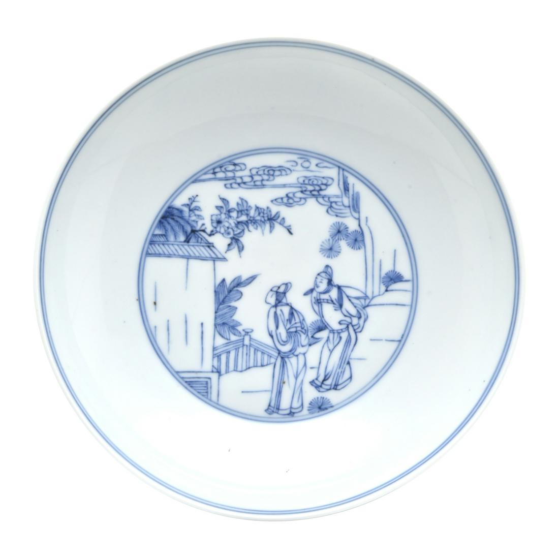 A Chinese Blue and White Circular Dish: A Chinese Blue and White Circular Dish. Finely painted, the interior depicts two robed gentlemen outside a temple wall in the mountain setting, the underneath decorated with a man on a boat in a mount