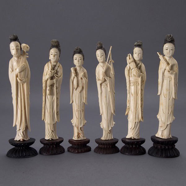 A Group of Six Ivory Female Musicians*: A Group of Six Ivory Female Musicians*, Each stands at varying heights wearing long draping robes while holding their respective instruments, some robes with incised borders displaying scroll work, ea