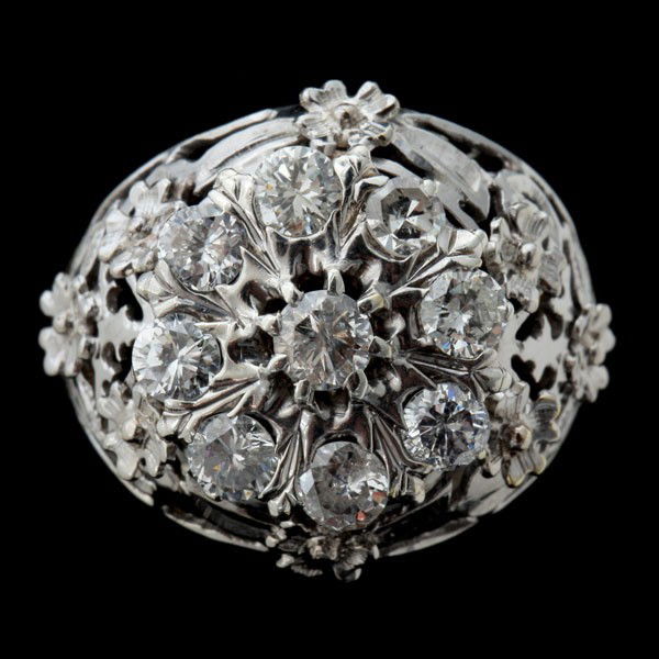 DIAMOND, 10K WHITE AND YELLOW GOLD RING.: DIAMOND, 10K WHITE AND YELLOW GOLD RING. Featuring ten round-cut diamonds, weighing a total of approximately 1.25 ct., prong set in a 10k white and yellow gold mounting. size 7 1/2, 2.6 dwts