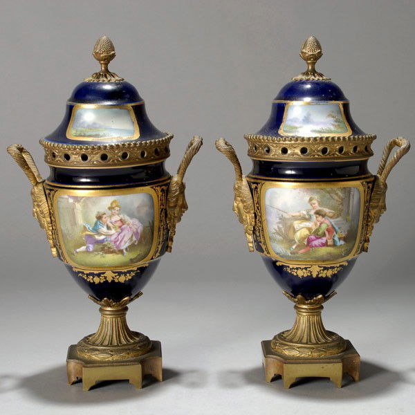 Pr Sevres Style Bronze Porcelain Covered Urns: Pair of Sevres Style Gilt Bronze Porcelain Covered Urns Each urn form centering a painted medallion of a child couple in 18th century dress seated in a parkland setting, adorsed by applied female mask
