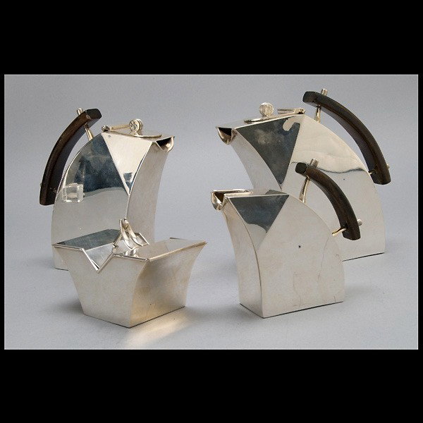 Italian Futurist Sterling Tea and Coffee Service: Italian Futurist Sterling Four Piece Tea and Coffee Service Each of geometric form fitted with walnut handles, the bases with an engine turned swirl design, comprising: a teapot, a coffee pot, a cream