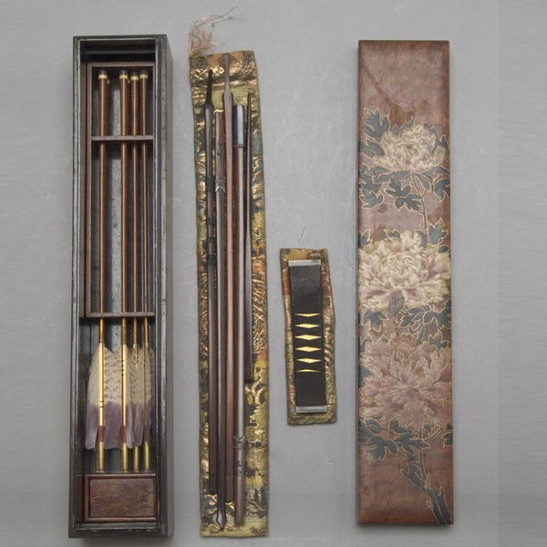 A Bow Set in a Lacquer Painted Wood Box: A Bow Set in a Lacquer Painted Wood Box, with brocade storage pouches and arrows, the box decorated with large peony blossoms {Height of box 13 3/4 inches}