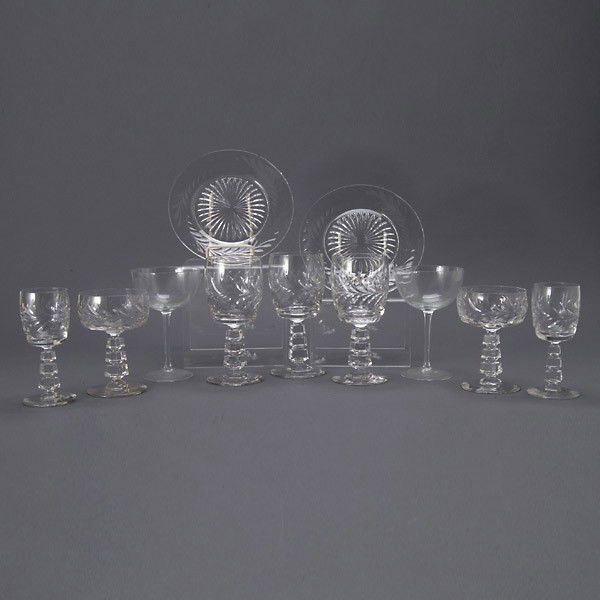 Suite of Art Deco Cut Glass Stemware and Plates: Suite of Art Deco Cut Glass Stemware and Plates: twelve water glasses (height 6 3/4 inches); eleven coupes (height 5 1/8 inches); eight cordials (height 5 1/2 inches, one with chip in base); and twelv