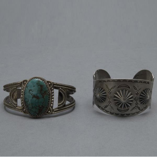 Native American Indian Two Navajo Braclets.: Native American Indian Two Navajo Braclets. One silver openwork cuff with large turquoise oval stone. 7 inch inner circumference. One Silver cuff with old traditional stmp work with repousee rosettes.