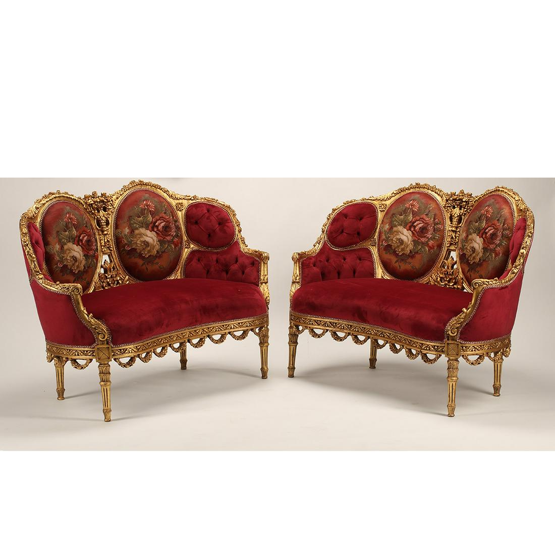 Pair of Louis XV Style Giltwood Settees: Pair of Louis XV Style Giltwood Settees. Tufted red velvet upholstery, floral panels to the backs. {Approximate dimensions: 36 1/2 high x 52 wide x 27 inches deep.}. Condition: Some rubbing and minor