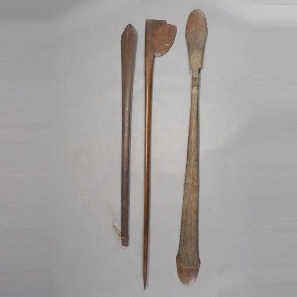 Three Oceanic ceremonial dance paddles wands club: Three OCEANIC dance paddles. MAORI, Solomon Islands, and Vanuatu. Wood with red brown stains. Length of one 53 1/4 inches. Maori with large chip off blade, other two in good condition.
