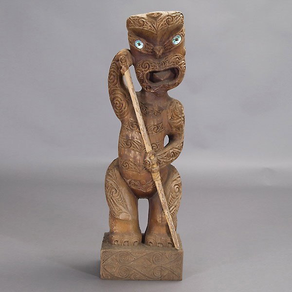 Maori standing figure: MAORI standing figure holding a staff, teko teko. Stained wood with weathered surface, mother-of-pearl eyes. Height 40 inches. In very good condition, usual cracks, small vertical crack.