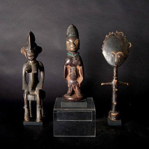 Three West African figures: Three West AFRICAN figures. An Ashanti akua ba (damage to hair); a Yoruba twin figure, ere ibeji; and a Senufo seated female. Height of Senufo 14 inches. In good to fair condition. Each mounted to a b