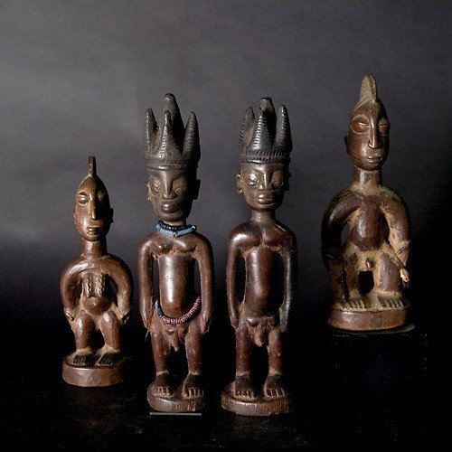 Two pair Yoruba twin figures ibeji: Two pair YORUBA twin figures, ibeji. Wood with brown stain. Height 11 1/4 inches. In good condition, some chips and cracks. Sale to benefit the programs of Folk Art International Resources for Educati