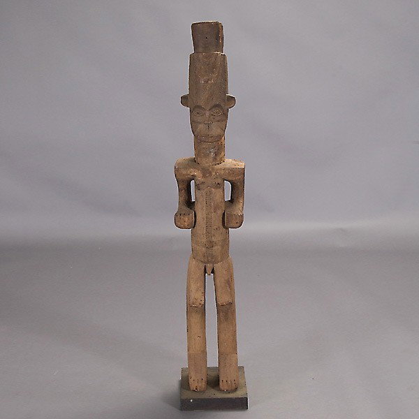 Igbo shrine figure.: IGBO shrine figure, Nigeria. Wood with brown color, earth pigment on shoulders. Height 51 1/2 inches. In very good condition, mounted to a base.