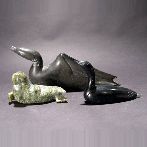 Three Inuit soapstone carvings: Three INUIT soapstone carvings. Two sea birds and a walrus. One signed on bottom "Isaac Takatak (Jr.)"; the others signed in Inuit on bottom. Length of largest 11 3/4 inches. Two in very good conditio