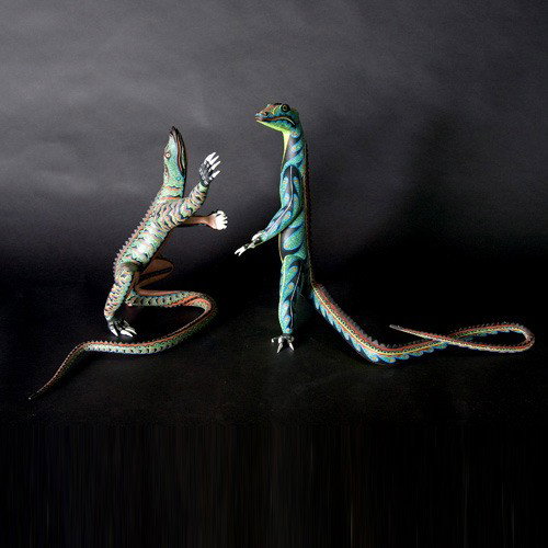 Oaxaca folk art Gerardo Ramirez Morales: GERARDO RAMIREZ MORALES (Oaxaca, Mexico). Two painted wood lizards. Each signed. Height of one 15 3/4 inches. In good condition, one toe missing. Sale to benefit the programs of Folk Art International