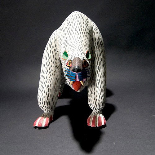 Oaxacan polar bear: MANUEL JEMENEZ & sons (Oaxaca, Mexic). "Polar Bear". Painted wood. Signed on underside. Length 18 inches. In very good condition.
