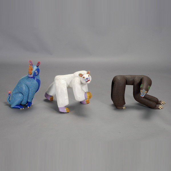 Three oaxaca Mexico folk art animals: Three OAXACA animals. A rhinocerous by Miguel Santiago; bear by Moises Jimenez; polar bear by Jose Hernandez & Sons. Painted wood. Length of bear 23 1/2 inches. All in very good, intact condition.
