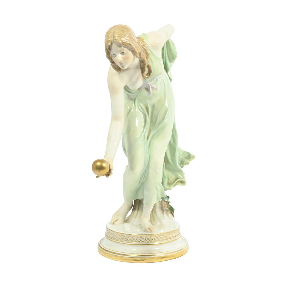 Meissen Porcelain Female Ball Player by Walter Schott: Meissen Porcelain Female Ball Player by Walter Schott. Woman partially clad in Classical green robe rolling a gold ball, standing on a round base. Blue underglaze crossed swords mark to the underside