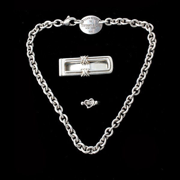 3 TIFFANY & CO. STERLING SILVER ITEMS.: COLLECTION OF THREE TIFFANY & CO. STERLING SILVER ITEMS. Including one sterling silver money clip, one sterling silver heart ring, size 4, together with one sterling silver Tiffany & Co. "Return to" n