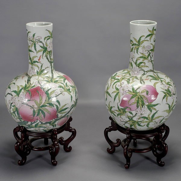 Two Massive Famille Rose Porcelain Longevity Vases: A Pair of Massive Famille Rose-Enameled Porcelain Longevity Vases, each of globular form depicting small iron-red bats in flight amidst flowering and fruitful branches, each base with a mark, with mat