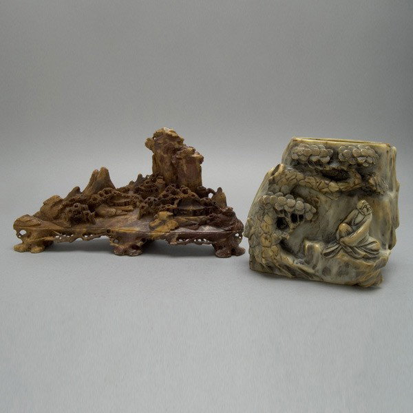 Two Soapstone Carvings: Two Soapstone Carvings, including a brush pot depicting a scholar beneath a pine tree and a horizontal landscape {Height of brush pot 6 inches} [Chips]