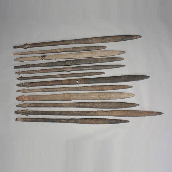 twelve papua new guinea fighting sticks: Twelve PAPUA New Guinea fighting sticks. Palmwood with low relief ornamentation in sections. Length of one 57 1/2 inches. Provenance: collected in the field by Bruce Lawes, circa 1960. In good conditi