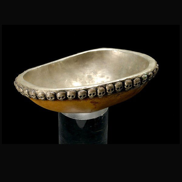 tibetan ceremonial cup tibet art: TIBETAN ceremonial cup. Bone and silver. Band around rim of grinning skulls. 2 x 7 x 5 1/4 inches. In very good condition.