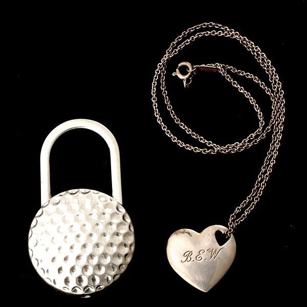 2 TIFFANY & CO. STERLING SILVER ITEMS.: COLLECTION OF TWO TIFFANY & CO. STERLING SILVER ITEMS. Including one sterling silver heart pendant-necklace together with one sterling silver golf ball key ring. 47.4 dwts