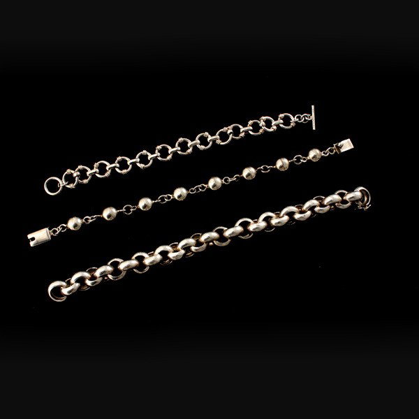 COLLECTION OF THREE STERLING SILVER LINK BRACELETS.: COLLECTION OF THREE STERLING SILVER LINK BRACELETS. Including one ball link and two circular link bracelets.