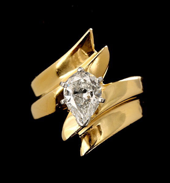 DIAMOND, 18K YELLOW GOLD RING.: DIAMOND, 18K YELLOW GOLD RING. Featuring one pear shape diamond, weighing approximately 0.90 ct., prong set in 18k white gold, completed by an 18k yellow gold ring. Size 4 1/2, 6.40 dwts