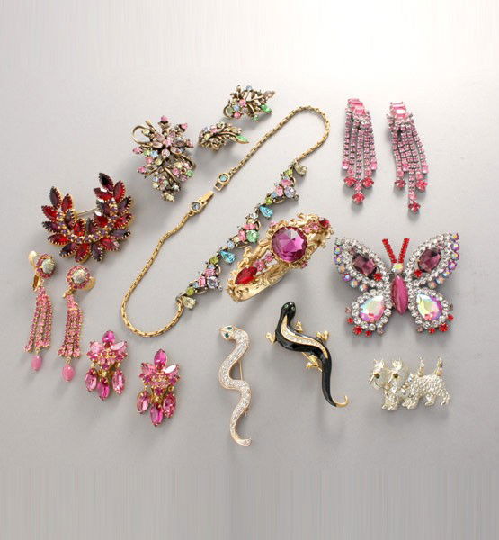 COLLECTION OF PINK RHINESTONE COSTUME JEWELRY.: COLLECTION OF PINK RHINESTONE COSTUME JEWELRY. Signed Coro matching necklace, brooch and earring set, Czech butterfly brooch, Clamper bracelet, three brooches and three pairs of clip on earrings.