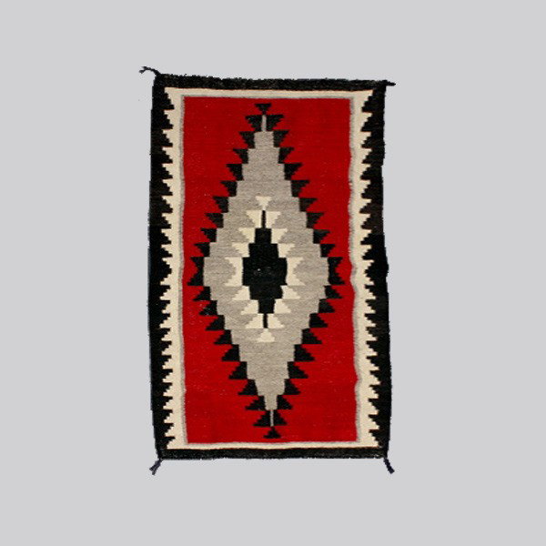 Native American Indian Navajo rug: NAVAJO rug. Red, white and black. Approximately 66 x 33 1/2 inches. In good condition, minor thinning from insects.