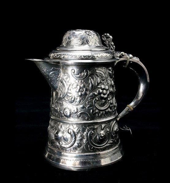 George III Sterling Lidded Stein, circa 1790: George III Sterling Lidded Stein The footed cylindrical form elaborately chased with rocaille scrolls, flowers and fruit, against a stippled ground, fitted with an auricular handle with ivory inserts,