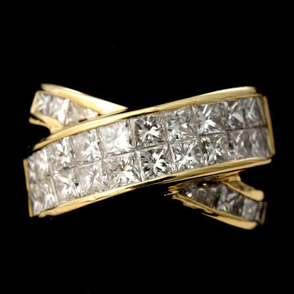 ERIC HANAN DIAMOND, 18K YELLOW GOLD RING.: ERIC HANAN DIAMOND, 18K YELLOW GOLD RING. Featuring twenty-nine princess-cut diamonds, weighing a total of approximately 3.00 cts., channel set in an 18k yellow gold cross over mounting. Size 6 1/2, 9
