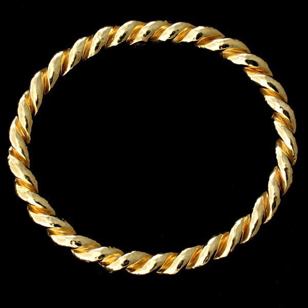 IPPOLITA 18K YELLOW GOLD BRACELET.: IPPOLITA 18K YELLOW GOLD BRACELET. The 18k yellow gold twist motif bangle measures approximately 7.00 mm in width, the largest internal diameter is 60.00 mm. 10.8 dwts