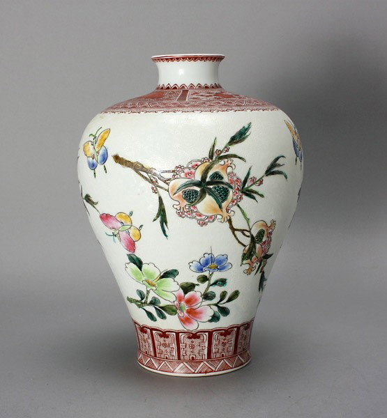An Enameled Porcelain Meiping Vase: An Enameled Porcelain Meiping Vase, Yong Zheng Mark, decorated with flower sprays and butterflies between coral red painted borders, against a white ground incised with scrolling ferns {Height: 11 1/4