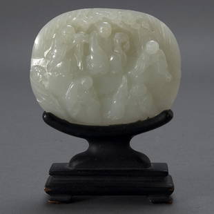 A White Jade Plaque with Figural Decoration: A White Jade Plaque with Figural Decoration, The irregular ovoid shape finely carved in relief with five luohan figures sitting within a rocky landscape beneath a pine tree, each holding various