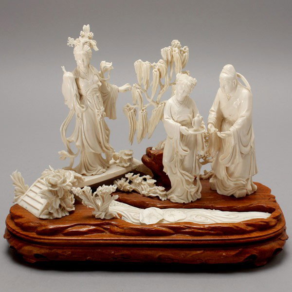 An Ivory Episodic Figural Group*: An Ivory Episodic Figural Group*, Most likely depicting a scene from the famous Chinese drama "Romance of the West Chamber," pieced together upon a carved wooden base illustrating Yingying standing on