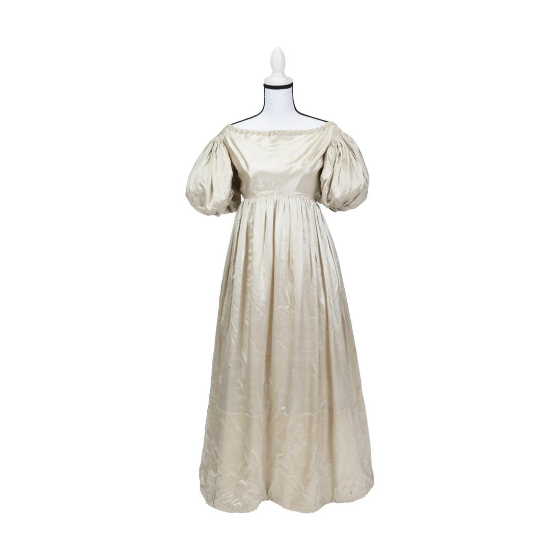 1832 Silk Satin Wedding Dress.: 1832 Silk Satin Wedding Dress. Off white silk satin dress lined with muslin lining to bodice and skirt about 14" from hem, and with tarlatan tulle meshe to interior of sleeves. High waisted dress with
