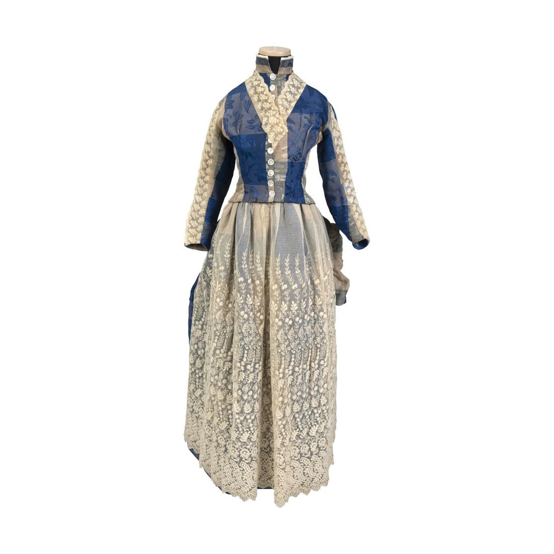 Ladies Two Piece Silk Brocade and Lace Dress, 1885.: Ladies Two Piece Silk Brocade and Lace Dress, 1885. Blue, grey and cream plaid silk, brocaded with Japonesque flowers, with collar, bodice front, sleeve inserts and apron of Margot lace. Mirror inlay 