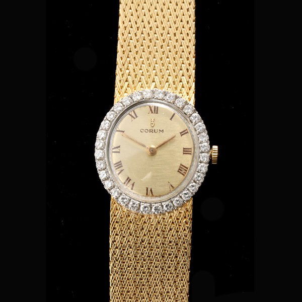 CORUM DIAMOND, 18K YELLOW GOLD WRISTWATCH.: LADY'S CORUM DIAMOND, 18K YELLOW AND WHITE GOLD WRISTWATCH. Dial: Oval, textured, gold tone, brown Roman numeral hour markers, gold pitched hands, Corum. Movement: 17 jewels adjusted to three position