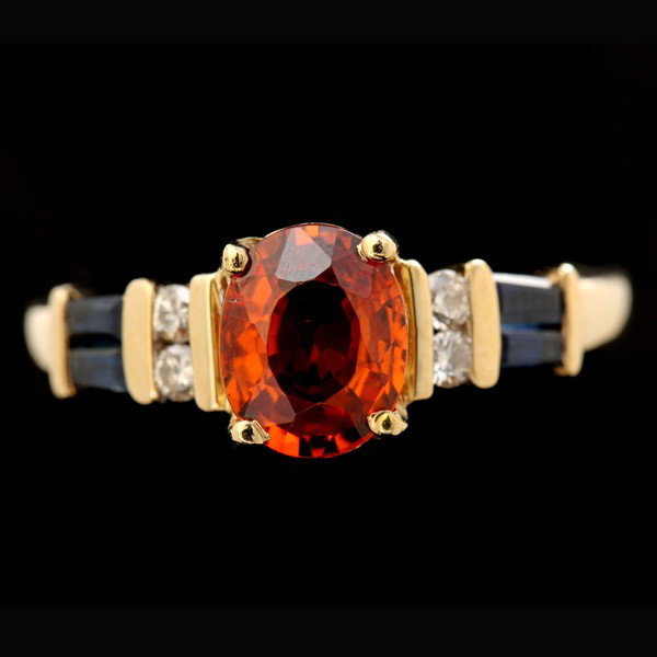 GARNET, DIAMOND, SYNTHETIC SAPPHIRE, 14K Y/G RING.: GARNET, DIAMOND, SYNTHETIC SAPPHIRE, 14K YELLOW GOLD RING. Centering one oval-cut garnet, weighing approximately 1.30 ct., flanked by twenty-one full-cut diamonds weighing a total of approximately 8.2