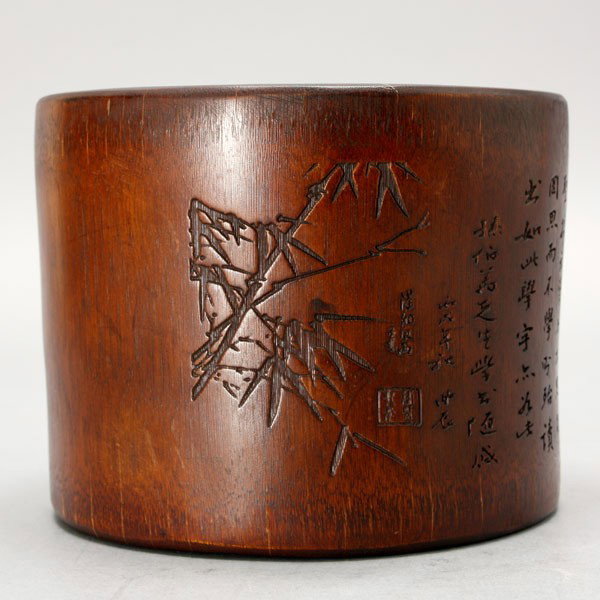 A Carved Bamboo Brush Pot: A Carved Bamboo Brush Pot, decorated with bamboo branches and a large inscription, with a lobed and scalloped rim {Height: 4 inches (10.1 cm)} [Age cracks, old chip to rim]