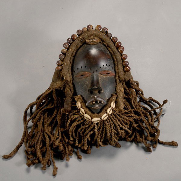 Dan Ivory Coast mask Africa tribal art: DAN mask, Blackened wood with woven and braided fiber wig and beard, cowrie shells and seed cases beads. Height (without beard) 10 1/2 inches. In very good condition.