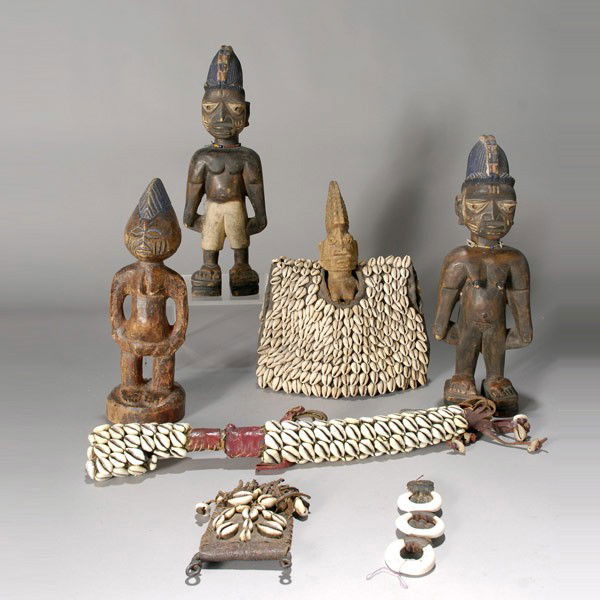 7 Yoruba Nigeria nigerian tribal art: Seven YORUBA items: four ibeji, one in cowrie cloak, a curved dagger, a leather pouch with cowries, an ornament with three shell rings. Height of ere ibeji 13 inches. All in good condition.
