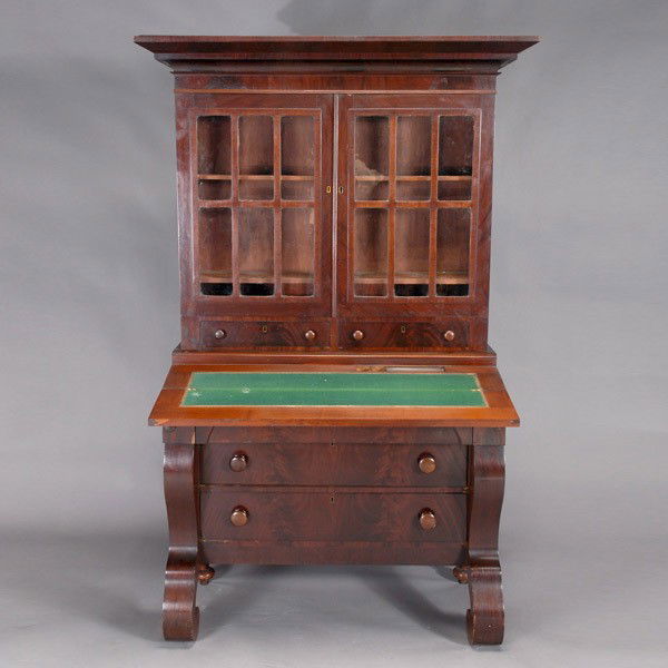 American Classical Mahogany Secretary Bookcase: American Classical Mahogany Veneer Secretary Bookcase, First Half 19th Century, The upper case with an outstepped cornice over a pair of panel molded and mullioned glazed doors, opening to an arrangem