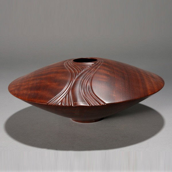 VAUGHN RICHMOND. Lathe turned hollow vessel: VAUGHN RICHMOND. "Ulmara" Lathe turned hollow vessel with jarrah and gold colored wire. 3 1/2 x 10 inches. Monogrammed on bottom. In good condition.